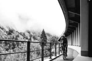 Swiss cyclist Marin Saint Exupery riding alongside a gallery up the Gotthard pass