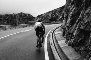 Cyclist Robin Gemperle out of the saddle pushing to the top of the Gotthard Pass in Switzerland